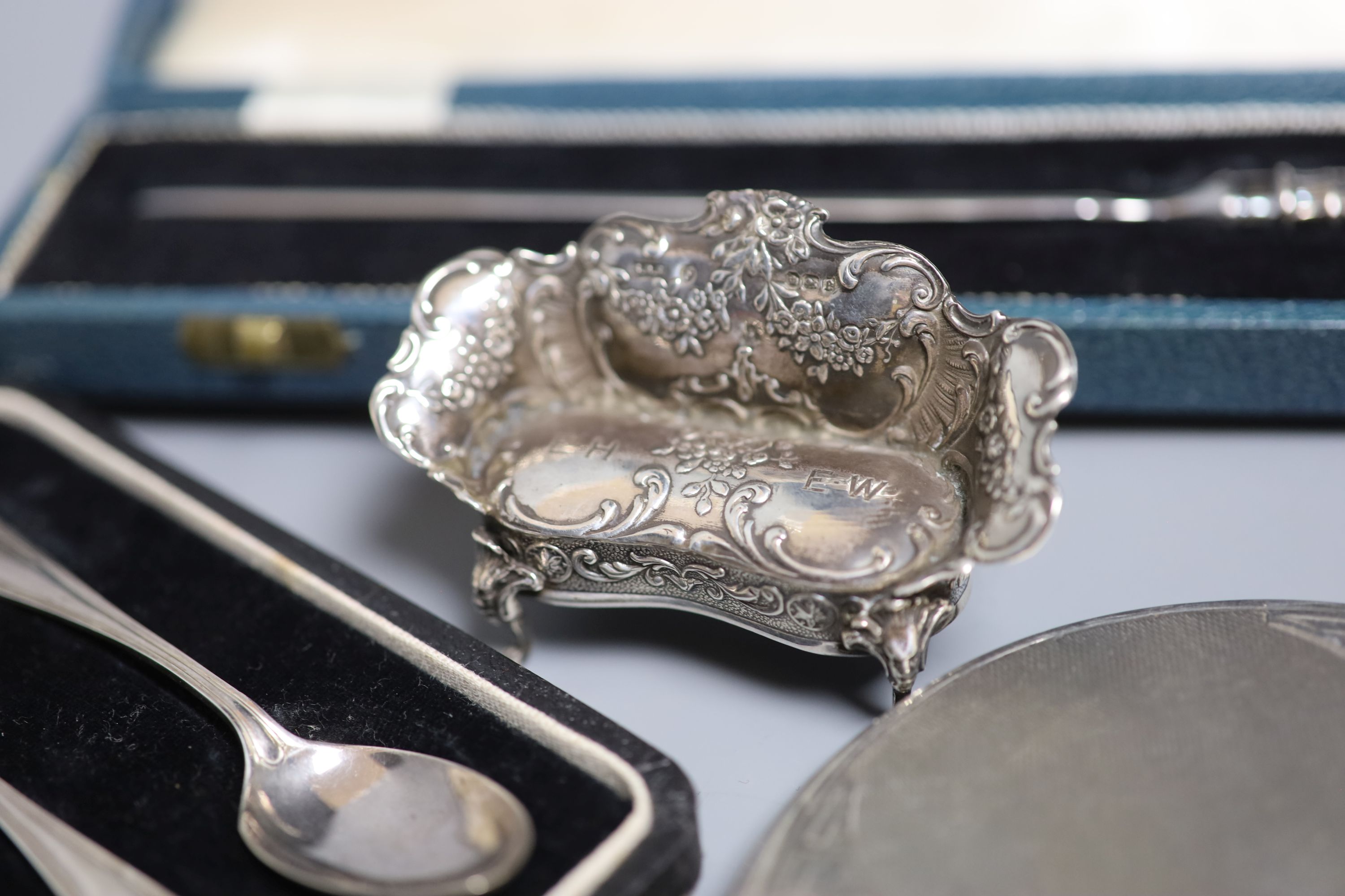 A silver cigarette case, brush set, cased spoons etc and a late Victorian miniature silver settee, Sheffield, 1897.